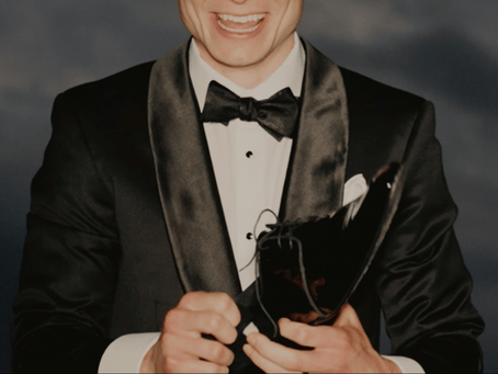 A groom in his black tie attire