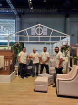 Four men posing in front of a white house frame, MillionDollarBabyCo.