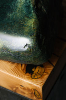 Pounamu (New Zealand Jade) on a custom GRC plinth and timber bed. By Unfound.