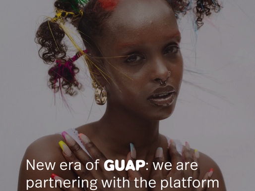 Portrait of a woman with colorful braided hair and long nails, posing against a gray background with article text about GUAP relaunch.