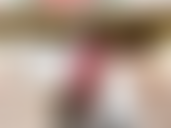 Two people smile beside a table full of books. Visible text emphasizes storytelling accessibility. Warm lighting.