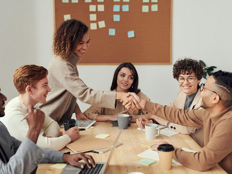 people shaking hands in meeting