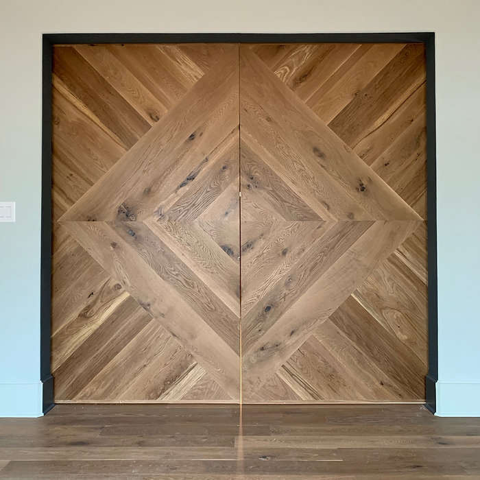 62 Screws custom White Oak chevron pattern barn doors with black hardware made and installed in Roswell, Georgia