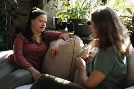 Two women chatting on a sofa