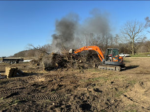 Burning brush from clearing the land on a excavation site