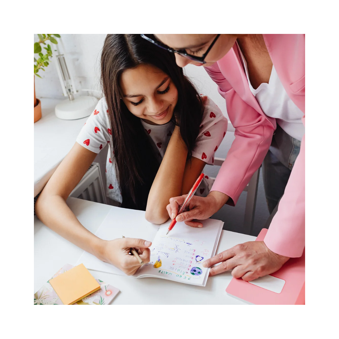 Teacher assisting a student at a desk at Summit Achievement Center