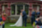Bride and groom share first kiss in front of the tea house at the Estate at Moraine Farm
