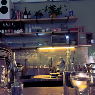 The bar at Rampant Wine Co. with a glass of non-alcoholic white wine on the counter
