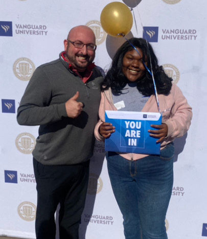 Headmaster Thomas Fallon with Eva Rhodes as Eva receives her college acceptance and scholarship letter from Vanguard University.