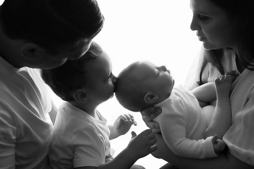 Big brother loving and kissing his new baby brother in beautiful family photography session with Storybook Photography, The Hills District, Sydney