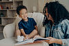 vecteezy_lovely-afro-american-mother-reading-book-to-her-little-son_11316835.JPG