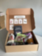 Close-up view of a box filled with assorted healthy snacks