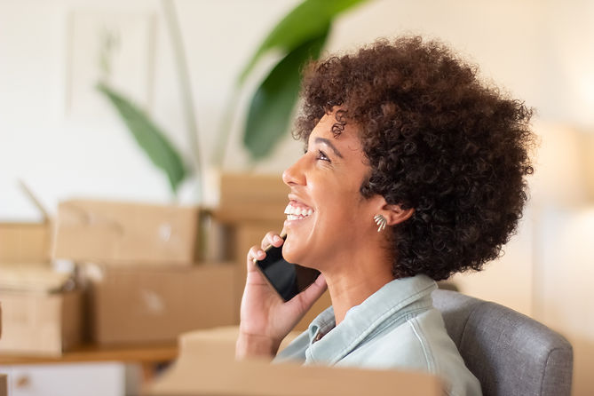 young-online-shop-worker-calling-client-smiling-happy-black-woman-working-home-office-surr