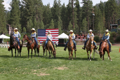Horses and cowboys in a field - The Lighthouse Project 