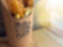 Small fish and chips in a cone with the Little Fishy logo stamped on it.