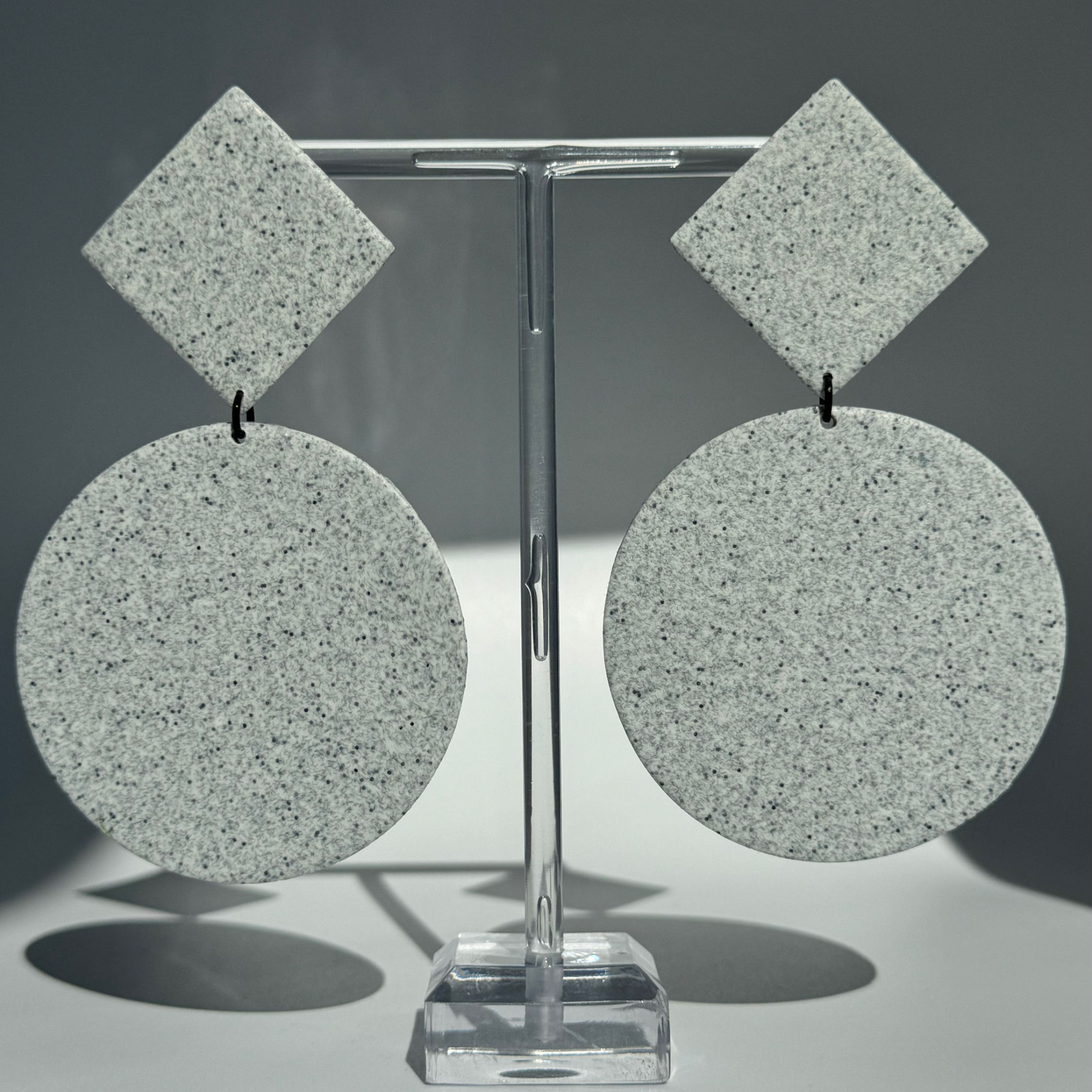 Double Geo XL Cement Earrings Bijoux Vii on the earring stand