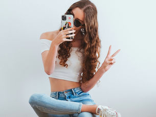 A micro influencer taking a picture from her smartphone highlighting the shifting influencer landscape as a key 2026 Influencer Marketing trend