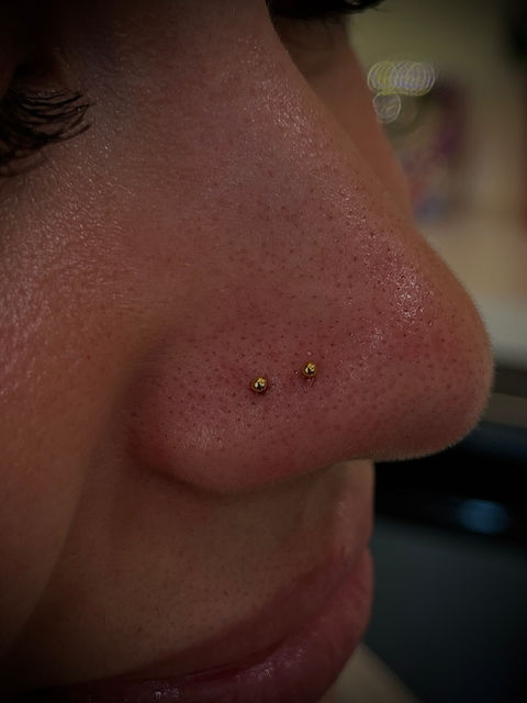Close-up of a stylish body piercing with fine 14 karat gold jewelry at Pierce Your Soul studio in Glendale, CA.