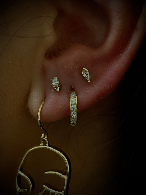Close-up of a stylish body piercing with fine 14 karat gold jewelry at Pierce Your Soul studio in Glendale, CA.