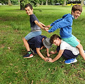 Two kids playing on the grass at a LevelUP English Camp