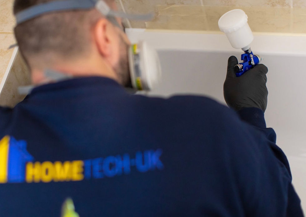 Bath repair with the technician using a spray gun