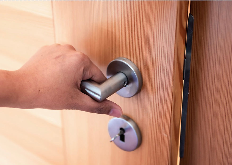 Hand on door handle with a slight opening to the door.
