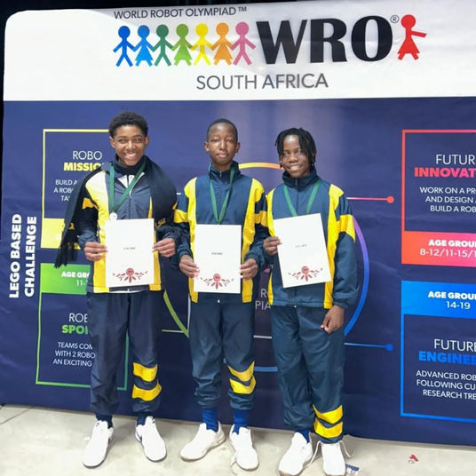 Learners posing with their certificates at the WRO.
