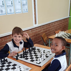 Primary school children developing strategy and focus while playing chess.