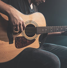 Man playing an acoustic guitar