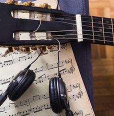 A headset, guitar, and lyrics.