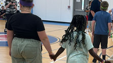 Dahlia holding hands with other residents