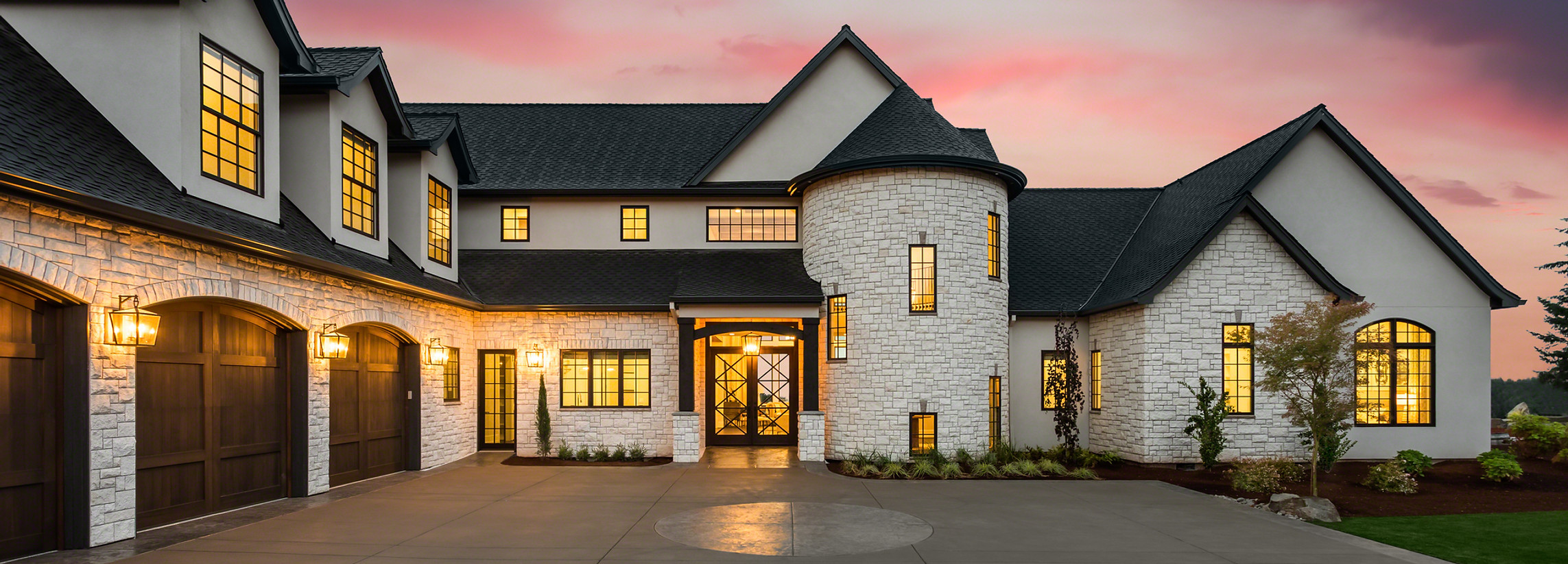 Beautiful Luxury Home Exterior at Twilight with Colorful Sunset Sky.jpg