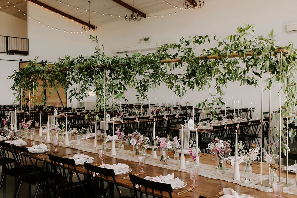 whimsical head table with bridge greenery centerpiece and floral arrangements by studio bloom wedding florist iowa city