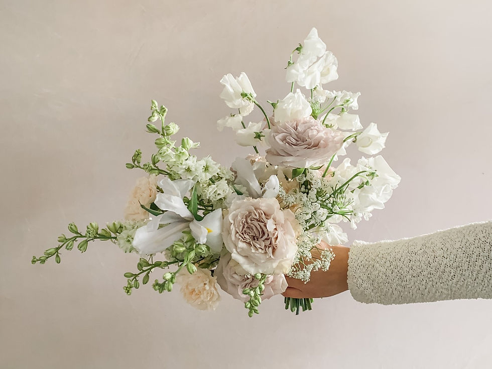Whimsical bridal bouquet in blush peach, lilac, and white by Studio Bloom Iowa weddings