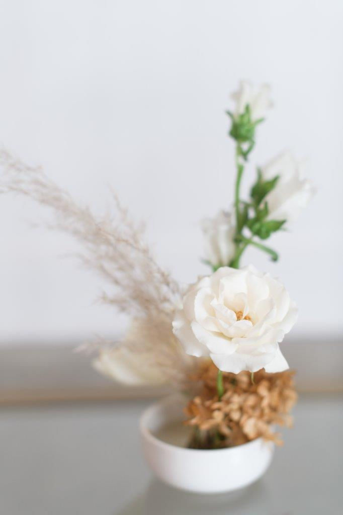 Minimalist neutral miniature arrangement with flower pin frog by Studio Bloom Iowa wedding florist of spray rose and pampas