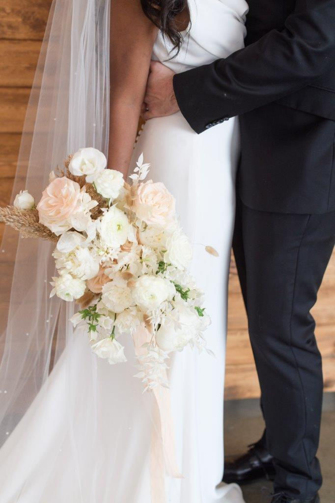 Studio Bloom Iowa weddings white neutral bridal bouquet of garden roses, ranunculus, lisianthus, pampas, and bleached ruscus