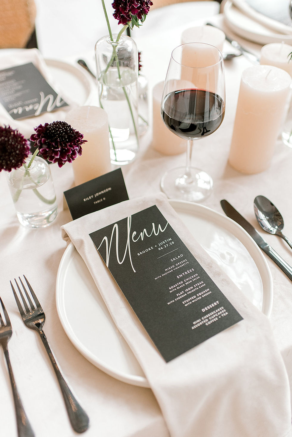 modern neutral minimalist wedding table with black menu card and red wine