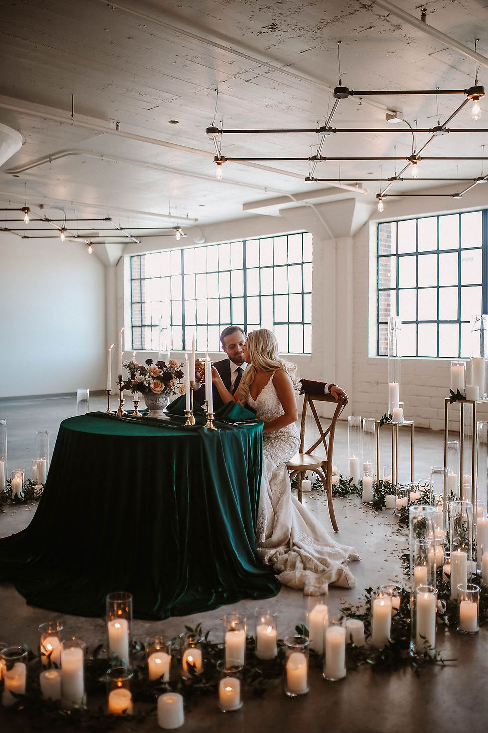 Sweetheart table surrounded by candles at the Harmac in Cedar Rapids