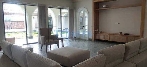 Modern living room with large glass windows and arched door