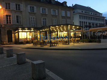 Outdoor restaurant pergola with lights at dusk