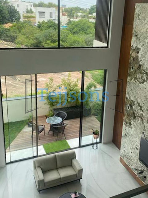 Modern living room with view to a wooden patio deck.