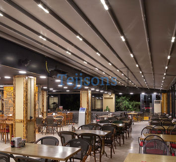 Retractable pergola with LED lighting over a restaurant patio