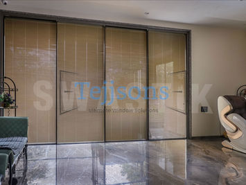 Large sliding glass doors with integral blinds.