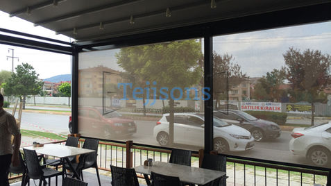 Outdoor patio with Zip Screens overlooking a street.