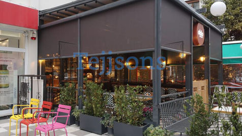 Outdoor restaurant patio with dark Zip Screens installed.