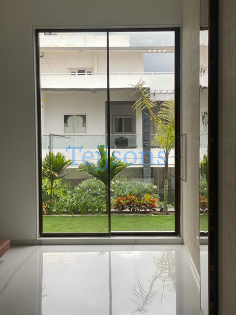 Large sliding glass door with garden view and Tersons logo