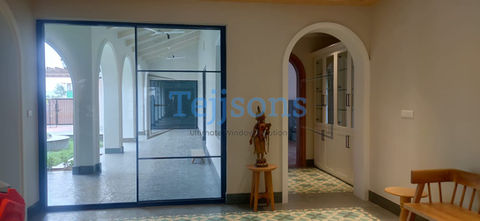 Tejjsons glass partition and arched doorway with statue