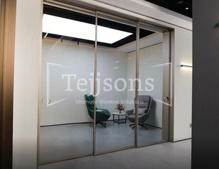 Tejjsons motorised glass sliding doors in a modern office.