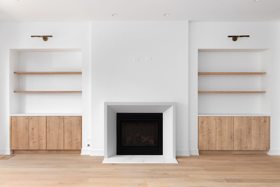 A fireplace detail with built-in white oak shelving and flooring, black lights mounted abo