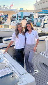 Two promotional models representing a marine brand at a boat show